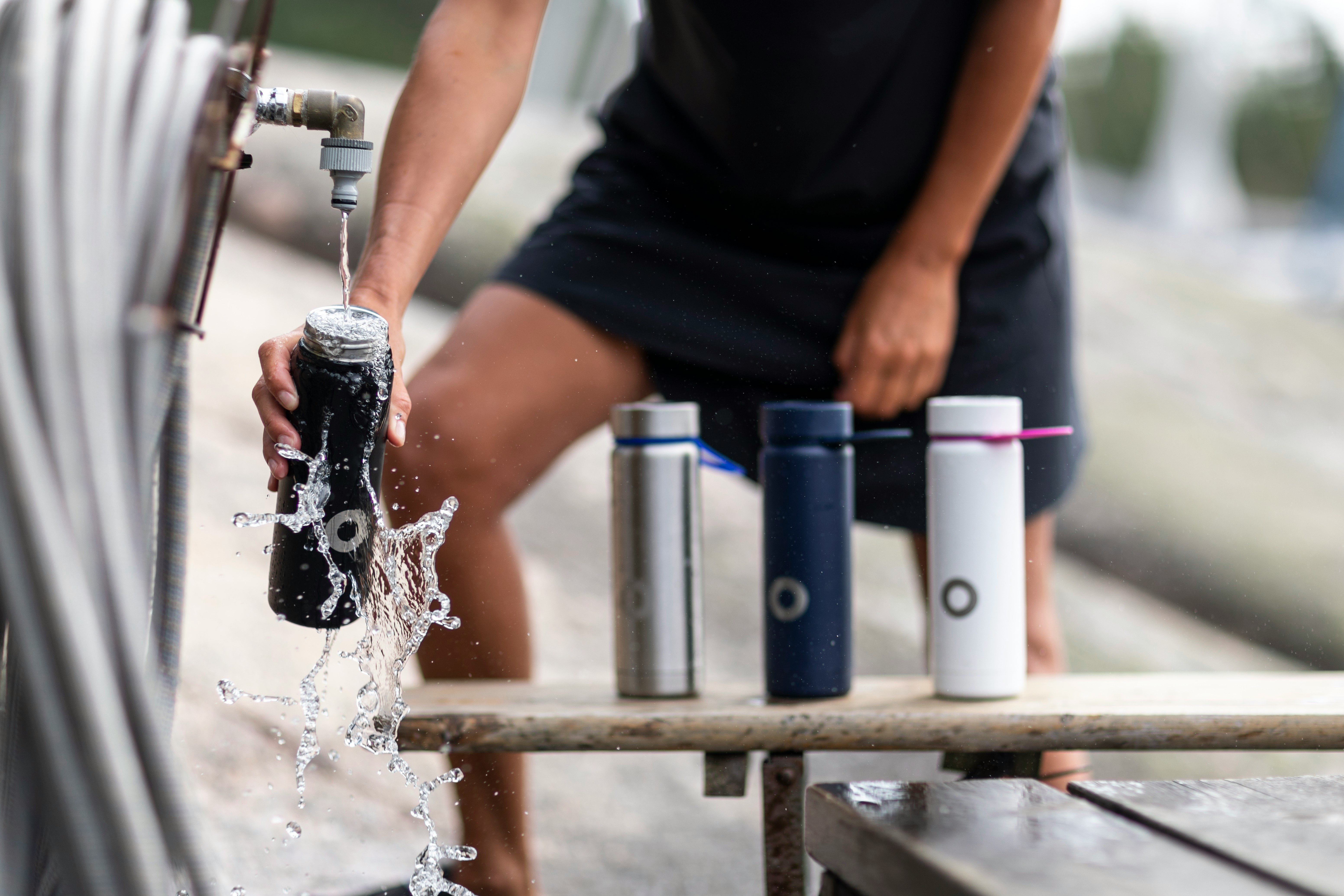 man in black t-shirt pouring water on water